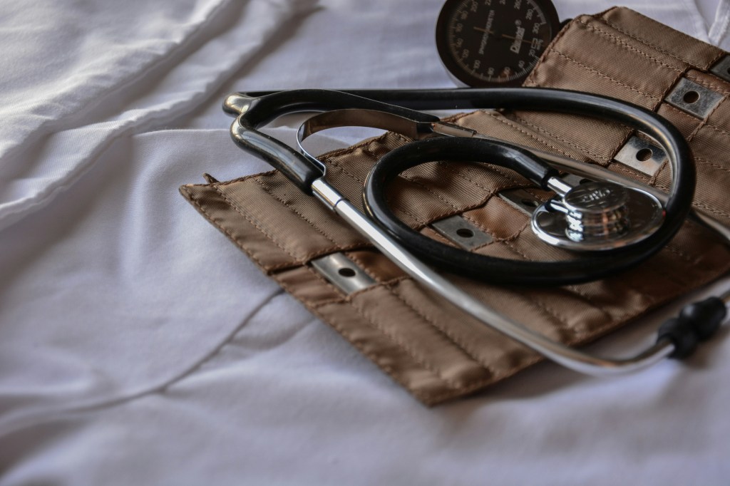 A stethoscope and a blood pressure cuff are ready for use. 