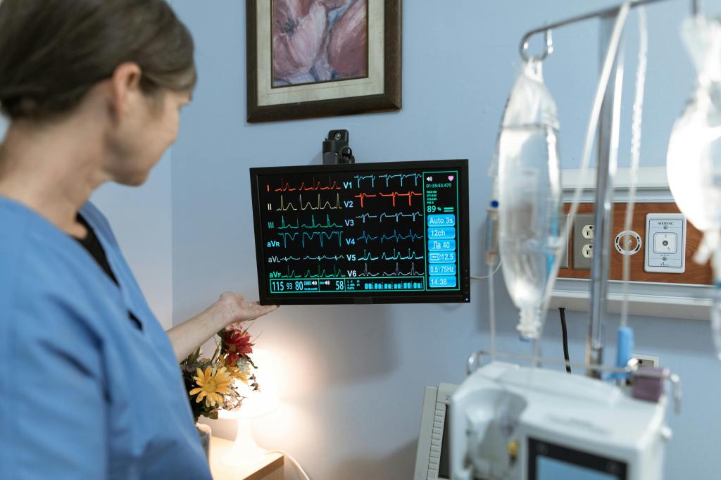 A paramedic student reading an EKG on a monitor for a patient. 