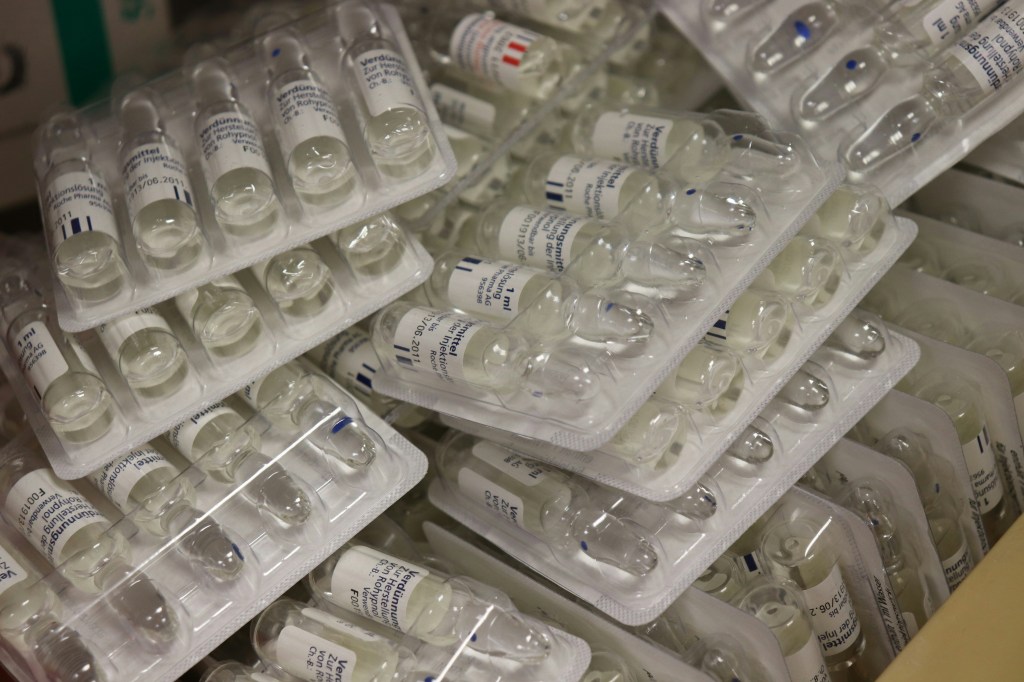 A bunch of glass vials containing medications for use by paramedics. There are five vials in each package. Paramedics train hard to memorize their medications. 