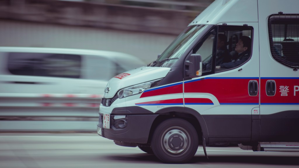Ambulance driving fast while transporting paramedics and a patient.