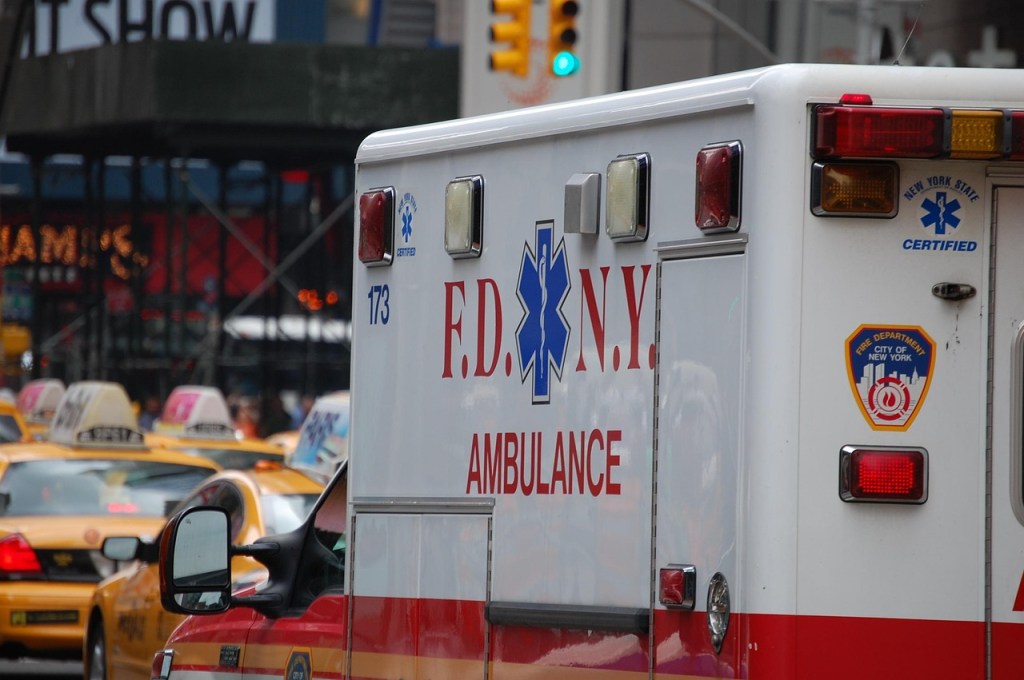 A FDNY ambulance stuck in traffic with a bunch of taxis. 