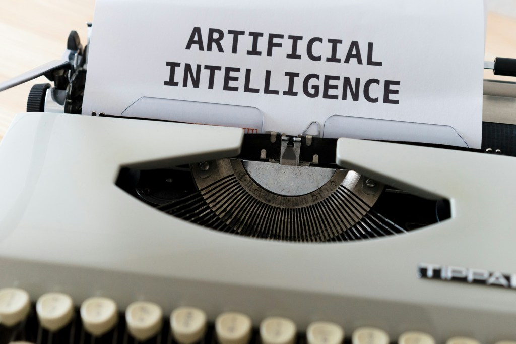 Here is a picture of a typewriter that says "Artificial Intelligence"